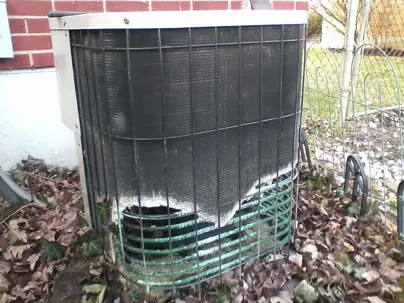 Damaged HVAC unit with corrosion visible on the bottom coils and fins.